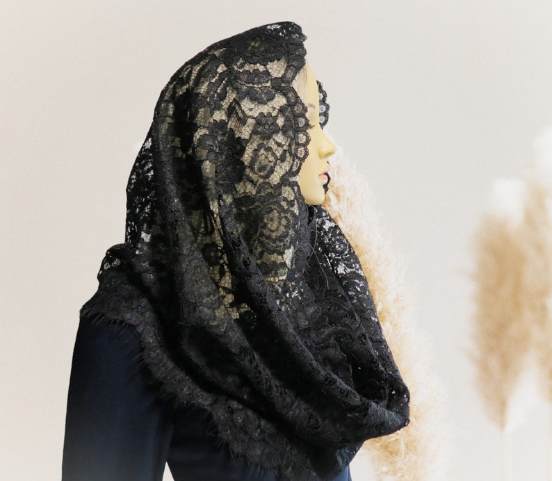 May include: A black lace mantilla, a traditional Spanish head covering, with intricate floral patterns.