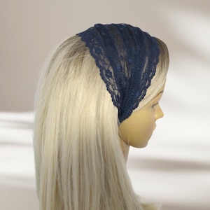 May include: A navy blue lace headband with a scalloped edge.