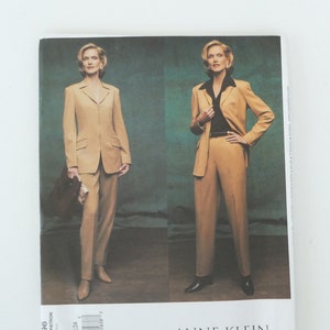 May include: A sewing pattern for a tan suit with a blazer and pants. The pattern is by Anne Klein, Vogue American Designer. The pattern number is 2696.