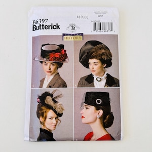 May include: A Butterick B6397 sewing pattern envelope featuring four distinct hat designs labeled A, B, C, and D. The white paper packaging displays photographs of individuals wearing various black hats with decorative elements like flowers, veils, and feathers.