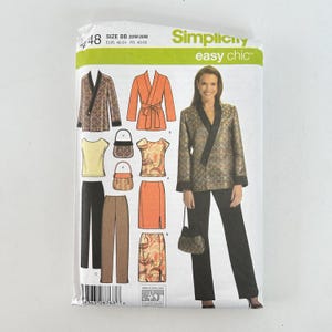 May include: A Simplicity Easy Chic sewing pattern, size BB 20W-28W, featuring illustrations of various women's clothing items, including jackets, tops, skirts, pants, and handbags. The pattern includes the text "Simplicity easy chic".
