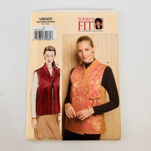 May include: Vogue V8000 Today's Fit by Sandra Betzina sewing pattern envelope featuring a sleeveless vest design. The cover displays a red vest with a tie closure and a gold patterned vest with a side tie, including a barcode and size D label.