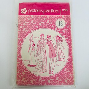 May include: A Patterns Pacifica sewing pattern envelope, number 310, size 13. The packaging is bright pink with a white floral geometric pattern. It features illustrations of four different dress styles labeled View A, View B, and View C.