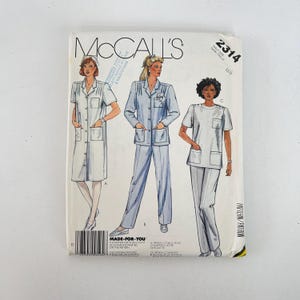 May include: A vintage McCall's sewing pattern featuring three different uniform designs. The pattern includes a white button-down dress, a light blue pantsuit, and a white short-sleeved top with matching pants. The pattern number is 2314.