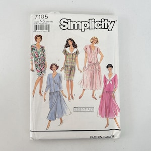 May include: A Simplicity sewing pattern envelope featuring illustrations of five different dress designs. The envelope is white with the number 7105 and the word "Simplicity" printed on it. The designs include dresses with various styles and colors.