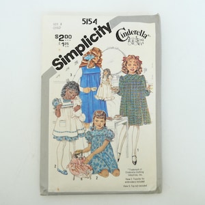 May include: Simplicity Cinderella sewing pattern for a child's dress, size 6. The cover features illustrations of girls in dresses. The pattern number is 5154. Includes a transfer for embroidery.