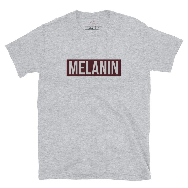 May include: A heather grey t-shirt with a maroon rectangle that says "MELANIN" in white text.