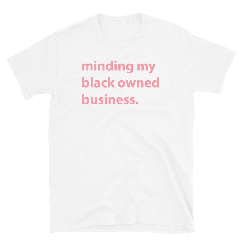 May include: White t-shirt with the text "minding my black owned business." printed in pink.