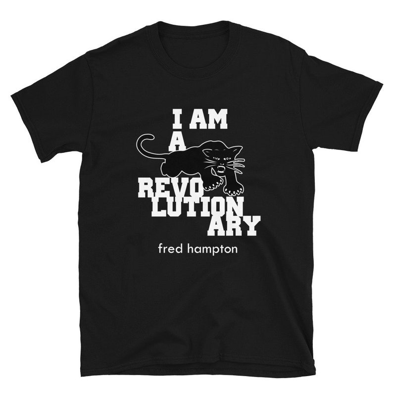 May include: Black t-shirt with white text that reads "I am a revolutionary" and a black panther graphic. The text "fred hampton" is below the graphic.