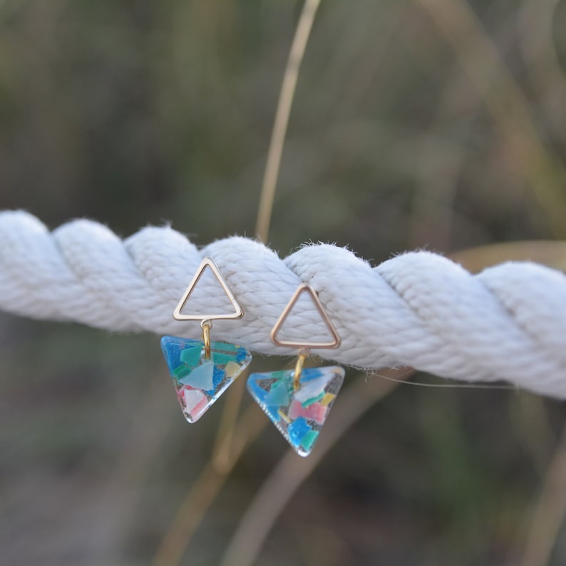 A pair of colorful triangle dangle earrings on a rope