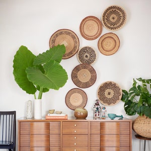 A group of five Handmade African Wall baskets called Binga baskets or Tonga baskets. They are used as boho woven wall hangings.