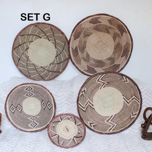 A group of five Handmade African Wall baskets called Binga baskets or Tonga baskets. They are used as boho woven wall hangings.