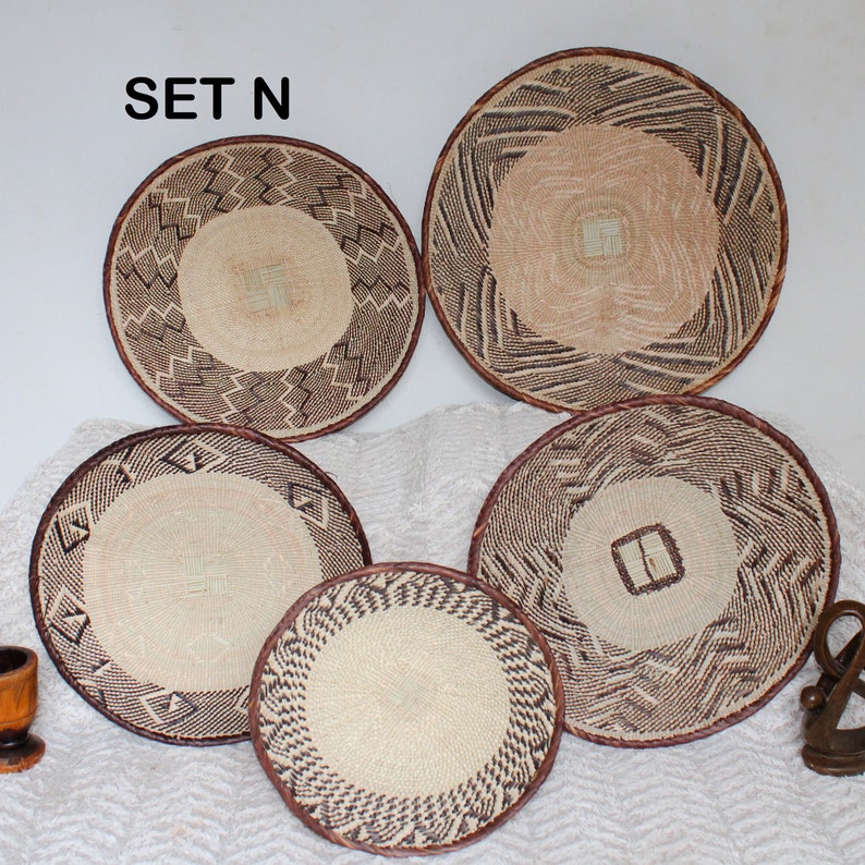 A group of five Handmade African Wall baskets called Binga baskets or Tonga baskets. They are used as boho woven wall hangings.