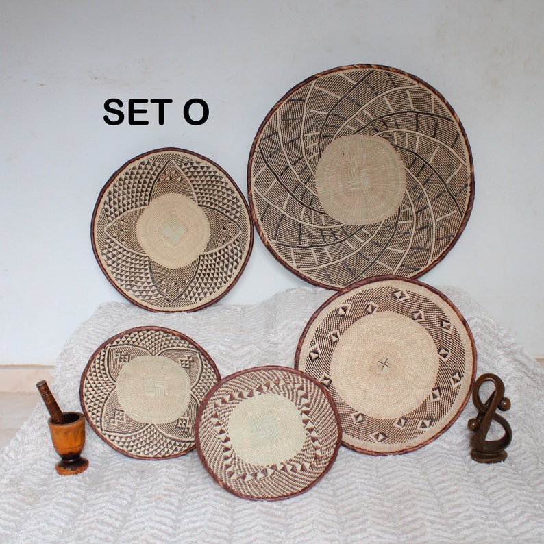 A group of five Handmade African Wall baskets called Binga baskets or Tonga baskets. They are used as boho woven wall hangings.