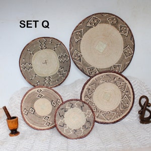 A group of five Handmade African Wall baskets called Binga baskets or Tonga baskets. They are used as boho woven wall hangings.