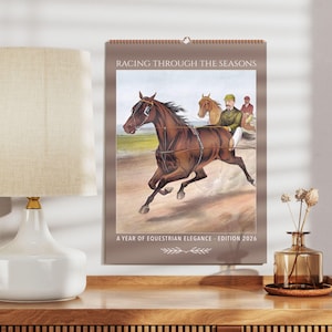 May include: A vintage-style calendar featuring a brown horse pulling a carriage with two people in it. The calendar is titled "Racing Through The Seasons" and says "A Year of Equestrian Elegance - Edition 2026".