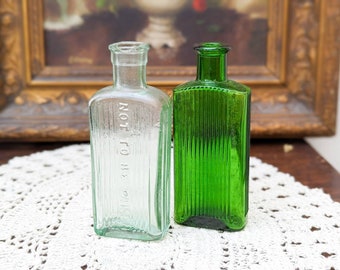 Two beautiful antique glass clear and emerald green apothecary bottles - Not To Be Taken - poison bottle - unique home décor - cute bottles