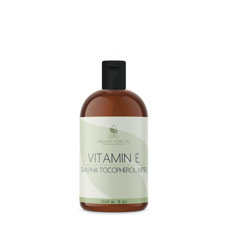 May include: A brown glass bottle with a black cap, labeled "OPO Organic Pure Oil" and "Vitamin E D-Alpha Tocopherol MT50". The bottle contains 8 ounces of vitamin E oil.