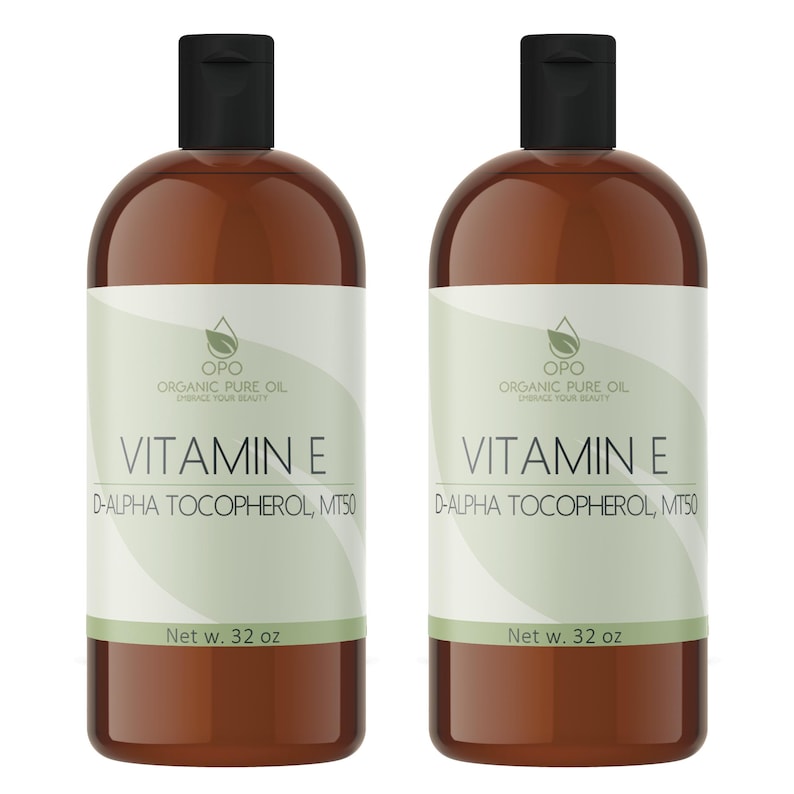 May include: Two brown glass bottles of Vitamin E oil, each with a white label that reads "OPO Organic Pure Oil Enhance Your Beauty" and "Vitamin E D-Alpha Tocopherol, MT50". Each bottle contains 32 fluid ounces.