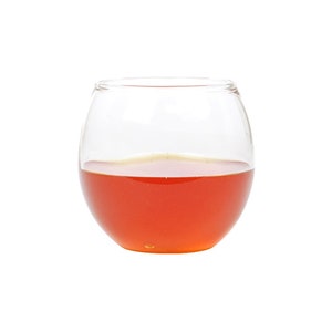 May include: A clear glass bowl filled with a bright orange liquid, likely honey.