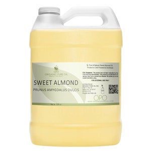 May include: A gallon jug of clear, light yellow sweet almond oil. The label reads "OPO Organic Pure Oil Embrace Your Beauty Sweet Almond Prunus Amygdalus Dulcis Pure & Natural Sweet Almond Oil Product is Cold Pressed & Unrefined FDA Disclaimer: This product has not been evaluated by the Food and Drug administration. This product is not intended to diagnose, treat, cure or prevent any disease. We advise you to do a patch test before using. For External Use Only Distributed by Organic Pure Oil Inc. 2109 S. Main St. Santa Ana, CA 92707 657-600-8100 Filled in the U.S. OPO www.organicpureoil.com Net Wt 128 oz"