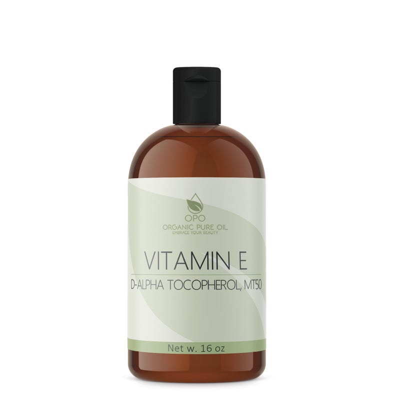May include: A brown glass bottle with a black cap, labeled "OPO Organic Pure Oil Enhance Your Beauty Vitamin E D-Alpha Tocopherol, MT50 Net w. 16 oz"