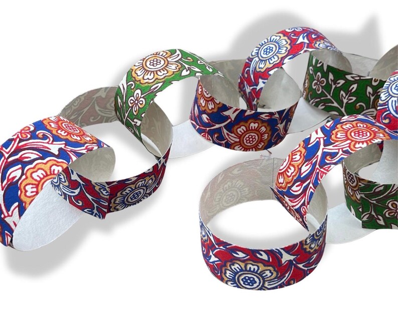 May include: Paper chain links with floral patterns in red, blue, orange, and green. The links are connected, creating a decorative chain. The design features a repeating flower motif on a white background.