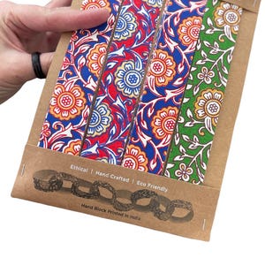 May include: A paperchain kit with four strips of floral block print in red, blue, and green. The kit is made from recycled cotton paper and is hand block printed in India. The packaging reads "Ethical | Hand Crafted | Eco Friendly."