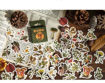 May include: A collection of vintage-style botanical stickers featuring mushrooms, leaves, and flowers. The stickers are in various shapes and sizes, with a color palette of greens, browns, and reds. A small green box with Chinese text is also visible.