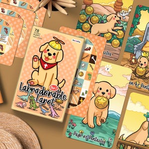 Può includere: Un mazzo di 78 carte dei tarocchi Labradorable con illustrazioni di cuccioli in stile cartone animato. La scatola mostra un cucciolo giallo con un cappello a elica e il testo Labradorable Tarot Ver 2. Diverse carte sono disposte a ventaglio.