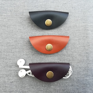 Leather earbud wrap handmade in black, brown, aubergine/eggplant. Headphone holder, cable case, cable keeper, cord organiser, earphone tidy