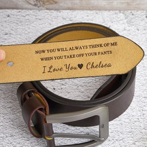 May include: A brown leather belt with a silver buckle. The belt's end is held up, revealing the engraved text: "NOW YOU WILL ALWAYS THINK OF ME WHEN YOU TAKE OFF YOUR PANTS I Love You Chelsea."