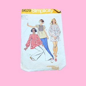 May include: A Simplicity 5629 sewing pattern envelope featuring illustrations of three different tops. The text includes the pattern number 5629, Simplicity, and size 15/16 with a bust of 35 inches and a waist of 27 inches. The background is white.