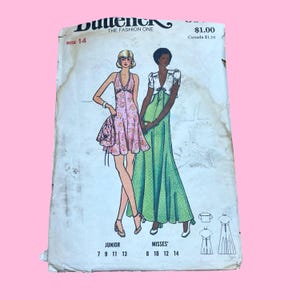 May include: Vintage Butterick sewing pattern featuring illustrations of two dresses. The pattern includes a halter dress with a floral print and a long green dress with white polka dots. The pattern is size 14 and costs $1.00.