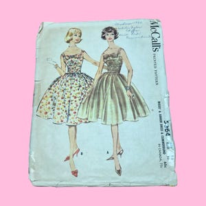 May include: Vintage McCall's printed pattern for a Misses' & Junior dress and cummerbund. The illustration features two women in dresses. The pattern includes the text "Christmas 1960" and "5364".