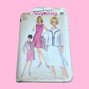 May include: Vintage Simplicity sewing pattern featuring illustrations of women's fashion. The pattern includes designs for dresses and a suit. The cover is aged with the text "Simplicity" and price of 65¢.