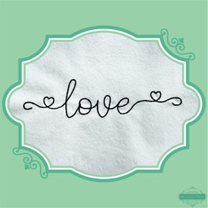 May include: A white fabric background with a black embroidered design of the word "love" with a heart on each side.