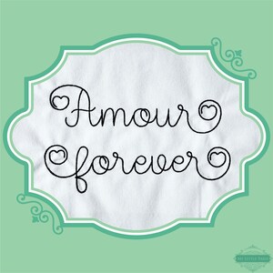 May include: A white fabric with a teal frame and the words "Amour forever" in black cursive with hearts.