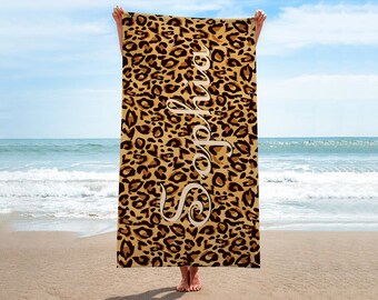 May include: A beach towel with a leopard print pattern and the name "Sophia" written in white script.