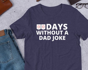 May include: A navy blue t-shirt with white text that reads "00 DAYS WITHOUT A DAD JOKE".