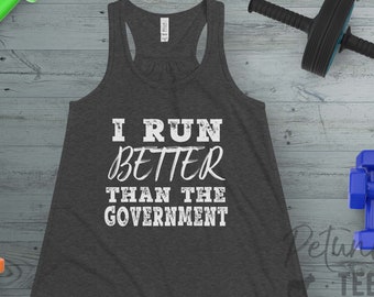 May include: A dark gray tank top with the text "I run better than the government" printed in white. The tank top is on a wood background with weights and a resistance band.