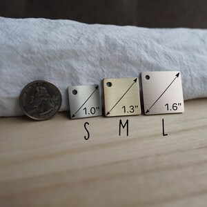 May include: Three square metal tags in different sizes, labeled "S", "M", and "L". The tags are 1.0", 1.3", and 1.6" wide, respectively.