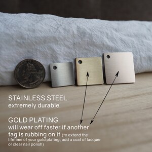 May include: Three small square metal tags in different finishes: silver, gold, and rose gold. The tags are made of stainless steel and have a brushed finish. The text on the image reads: "Stainless Steel extremely durable" and "Gold Plating will wear off faster if another tag is rubbing on it (to extend the lifetime of your gold plating, add a coat of lacquer or clear nail polish)"
