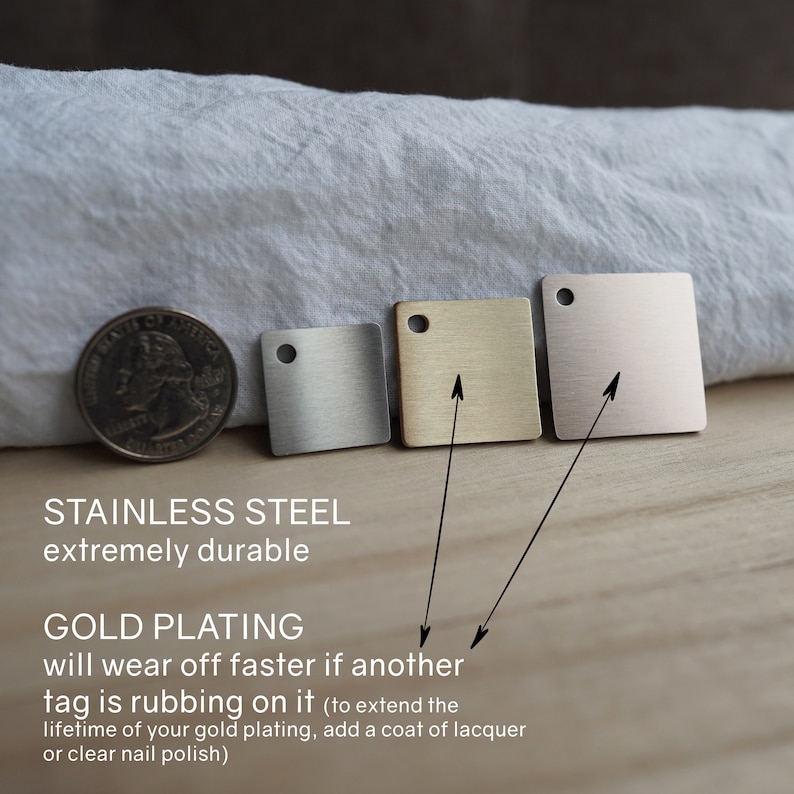 May include: Three small square metal tags in different finishes: silver, gold, and rose gold. The tags are made of stainless steel and have a brushed finish. The text on the image reads: "Stainless Steel extremely durable" and "Gold Plating will wear off faster if another tag is rubbing on it (to extend the lifetime of your gold plating, add a coat of lacquer or clear nail polish)"