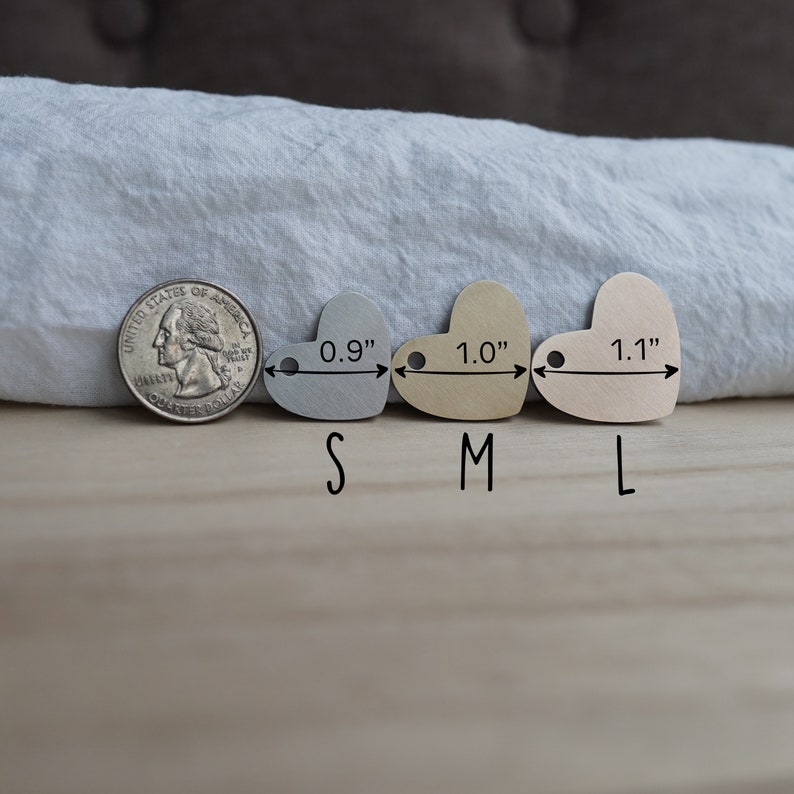 May include: Three heart-shaped metal tags in different sizes: 0.9 inches, 1.0 inches, and 1.1 inches. The tags are silver, gold, and rose gold.