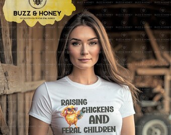 May include: White t-shirt with the text "RAISING CHICKENS AND FERAL CHILDREN" in black. The shirt features a cartoon chicken wearing sunglasses. The Buzz & Honey logo is in the upper left corner.