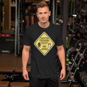 Cryptid Crossing Caution Sign – Bigfoot, UFO & Mothman Sticker Design Unisex t-shirt