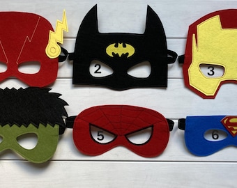 May include: Six felt superhero masks in different colours and designs. The masks are numbered 1 through 6. The masks are for kids and are made of felt.