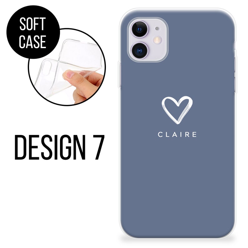 May include: A soft phone case in Design 7, shown in a close-up view. The case is a muted blue with a white heart and the name "CLAIRE" printed below. The words "SOFT CASE" are in a black circle, and "DESIGN 7" is printed in large black letters.