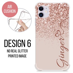 May include: A clear phone case with a pink and rose gold glitter design. The case has a raised edge around the camera lens and a printed image of the word "Ginger" in a cursive font.